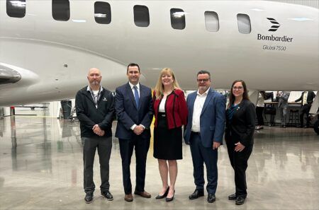 Bombardier expands FastTrack A&P certification programme to Connecticut Five people in business attire standing in a hangar in front of a Bombardier Global 7500 aircraft fuselage