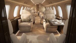 Luxurious cream private jet cabin with dining table and armchairs