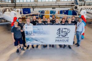 Staff hold banner celebrating Prague Service Centre's 15th anniversary