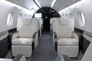 Refurbished Embraer Legacy 600 cabin with white and grey leather seats