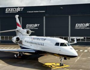 Constructor-branded Dassault Falcon jet parked outside ExecuJet MRO facility