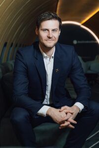 Portrait of Paulius Cegis seated inside an aircraft cabin