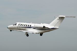 Cessna Citation CJ3 Gen3 light jet in flight against a grey sky