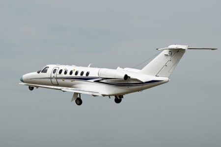 Cessna Citation CJ3 Gen3 light jet in flight against a grey sky