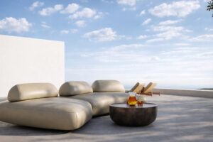 A cream leather-look modular sofa on a sunlit outdoor terrace under a blue sky