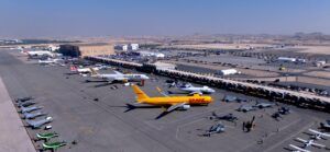 Aerial view of various aircraft types and helicopters parked on the apron at Bahrain International Airshow