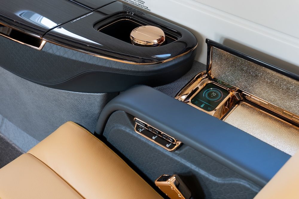 Close-up of a cabin sideledge with a cup holder and control panel