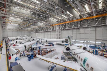 ExecuJet MRO Services Middle East completes Legacy 650 refurbishment Interior of an aircraft MRO hangar showing several business jets undergoing work