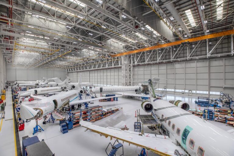 ExecuJet MRO Services Middle East completes Legacy 650 refurbishment Interior of an aircraft MRO hangar showing several business jets undergoing work