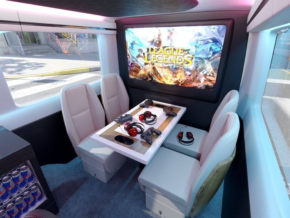 Mercedes-Benz Sprinter gaming interior with large screen and table with controllers