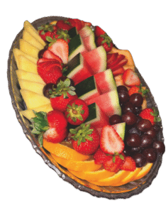 Oval dish of fresh fruit, including slices of watermelon, cantaloupe, pineapple and orange, as well as strawberries and red grapes