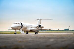 Business jet on apron with airstairs deployed
