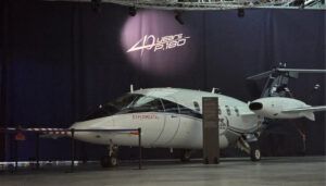 Piaggio P.180 experimental aircraft displayed beneath '40 years' banner