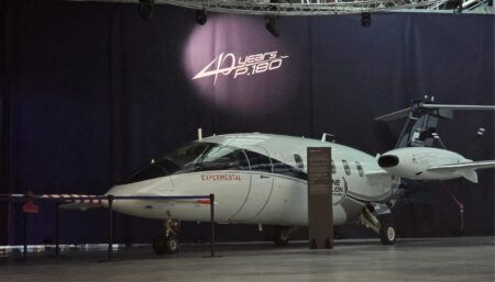 Piaggio P.180 experimental aircraft displayed beneath '40 years' banner