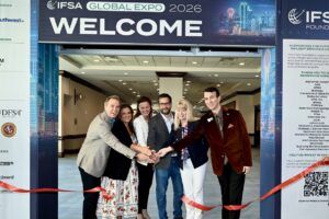 Six people cutting red ribbon at IFSA Global Expo entrance
