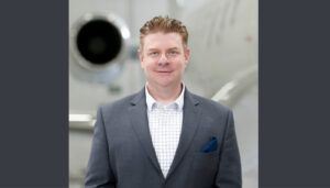 Justin Kinckle in front of aircraft engine