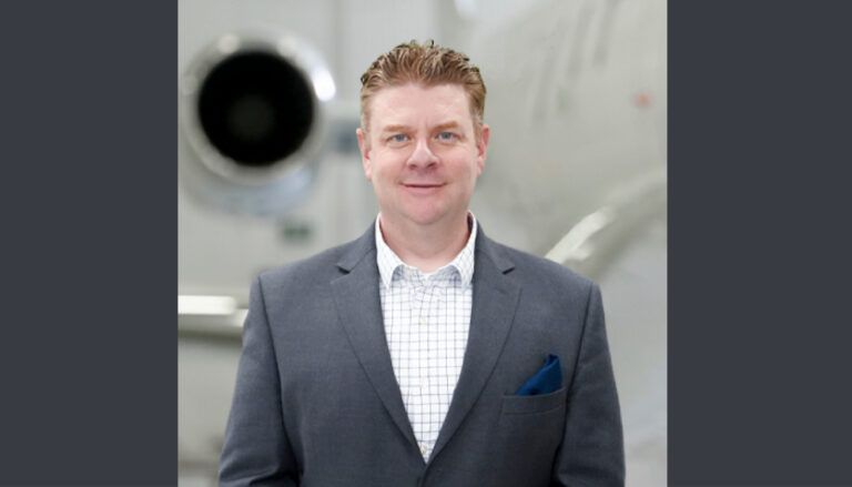 Justin Kinckle in front of aircraft engine