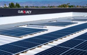 Rooftop solar panels on Clay Lacy building with mountains behind