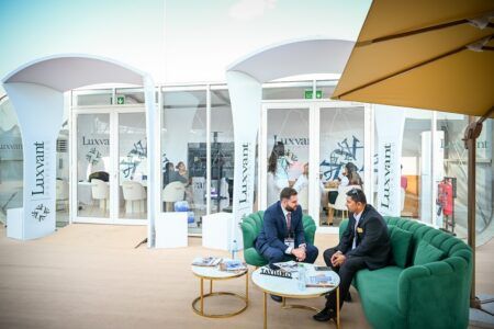 MEBAA Show 2026 adds experience zone to Luxury Boulevard Two men talking on green sofas outside Luxvant Properties pavilion